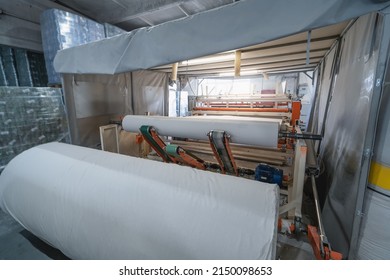 Toilet Paper Production. Machine With A Large Roll Of Recycled Paper