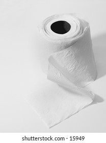 A toilet paper roll, unrolled and rolled up again, isolated on white.