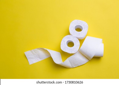 Toilet Paper Rolls On Yellow Background. Everyday Objects In Copy Space. Shortage Of Raw Materials During Period Of Coronavirus. A Popular Product On Market. Delivery Of Goods For House