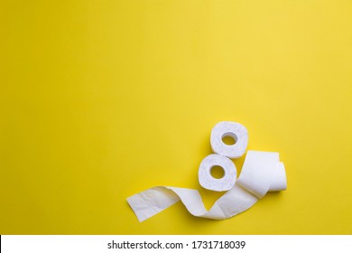 Toilet Paper Rolls On Yellow Background. Everyday Objects In Copy Space. Shortage Of Raw Materials During Period Of Coronavirus. A Popular Product On Market. Delivery Of Goods For House