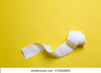 Toilet Paper Rolls On Yellow Background. Everyday Objects In Copy Space. Shortage Of Raw Materials During Period Of Coronavirus. A Popular Product On Market. Delivery Of Goods For House