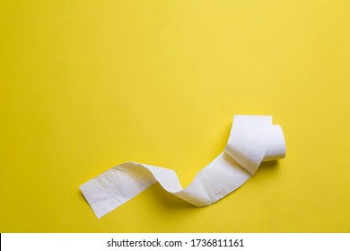 Toilet Paper Rolls On Yellow Background. Everyday Objects In Copy Space. Shortage Of Raw Materials During Period Of Coronavirus. A Popular Product On Market. Delivery Of Goods For House