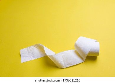 Toilet Paper Rolls On Yellow Background. Everyday Objects In Copy Space. Shortage Of Raw Materials During Period Of Coronavirus. A Popular Product On Market. Delivery Of Goods For House