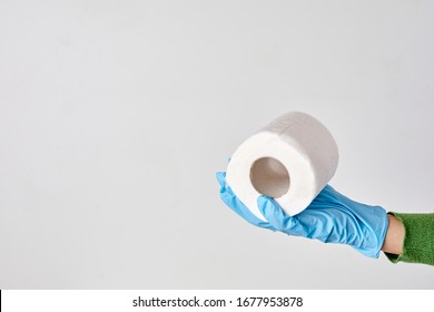 Toilet Paper Shortage Concept. Woman Holding Toilet Paper Roll.