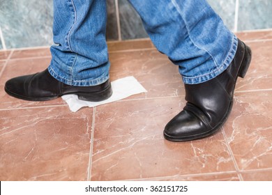 Toilet Paper Stuck To The Sole Of Man's Shoe