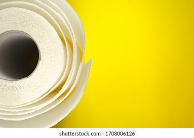 Toilet Paper Top View. Paper Towel Roll On Yellow Background. Hygiene Stuff For Everyday. Banner Template With Body Care Products And Copy Space.