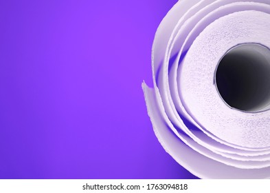 Toilet Paper Top View. Paper Towel Roll On Violet Background. Hygiene Stuff For Everyday. Banner Template With Body Care Products And Copy Space.