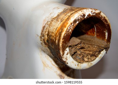 Toilet Pipe Clogged With Urine Stone.  Toilet Pipe Clogged With Limescale. Perennial Deposits Of Urinary Stone In The Toilet Pipe. Dirty Toilet.