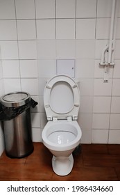 Toilet In The Public Restroom. Simple Bathroom Interior. Stop At A Gas Station While Traveling.