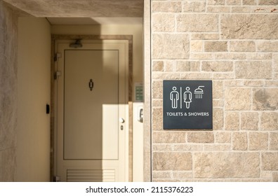 Toilet and shower room. Public toilets and showers with a sign. exterior, facade of beach toilet and showers. Customer shower facilities sign at public toilet