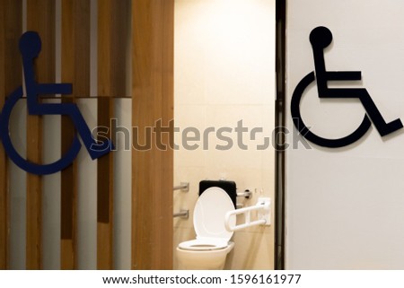  
Toilet sign disabled in a public convenience area.