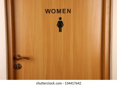 Toilet sign on wooden door