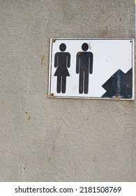 Toilet Sign Stuck To The Wall Concrete