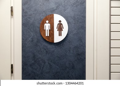 Toilet, Wc Icon, Round Wooden White And Brown Sign On Restroom Door In The Hallway, Restaurant, Lobby. Concept Sign Of Toilet Room At The Airport, Cafe, Bar, Hotel, Train Station