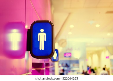 Toilets Icon. Blue Public Restroom Signs With A Male Symbol. Interior Of Airport Terminal.