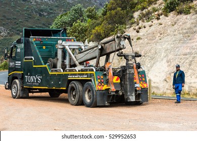 Toitskloof Pass, South Africa - November 21, 2016: The Driver Of A Heavy Duty Wrecker Used For Towing Semi Trucks Is Making A Break Before Towing A Large Truck Along The Garden Route Near Cape Town In