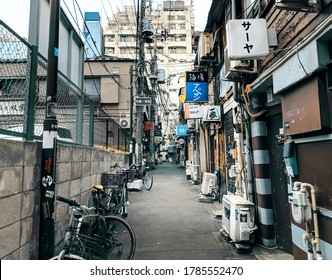 Tokyo - 26 March 2019 - View Of Grungy Japanese Style Alleyway With Bars At Golden Gai In Tokyo, Japan