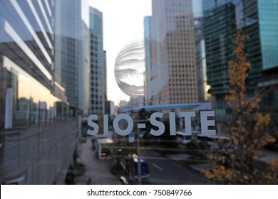 TOKYO - DEC 21, 2014: Glass facade of Shiodome, Sio-Site signage on the elevated walkway in Shiodome, Tokyo. Shiodome is a former railway terminal that was transformed into Tokyo's most modern area.