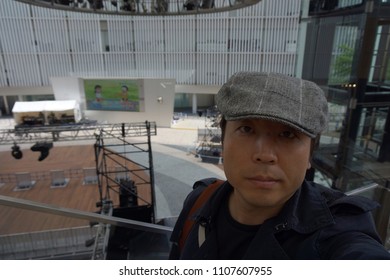 Tokyo, Japan, 05 07 2017 : A Man Standing In Front Of Big Outdoor Screen Of Tv Asahi At Roppongi Hills