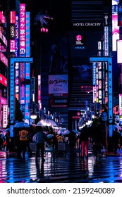 Tokyo, Japan - 05.2022: Abstract Pedestrian With Neon Light From Billboards And Advertisement In Nightlife District Of Kabukicho, Shinjuku, Japan. Nightlife, Futuristic Metaverse City, And Cyberpunk.