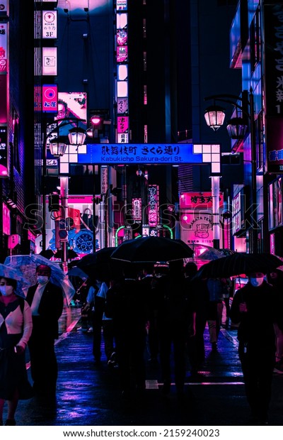 Tokyo, Japan - 05.2022: Abstract Pedestrian\
with Neon light from billboards and advertisement in nightlife\
district of Kabukicho, Shinjuku, Japan. Nightlife, Futuristic\
metaverse city, and\
cyberpunk.