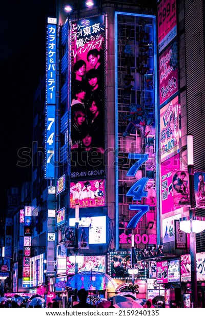 Tokyo, Japan - 05.2022: Abstract Pedestrian\
with Neon light from billboards and advertisement in nightlife\
district of Kabukicho, Shinjuku, Japan. Nightlife, Futuristic\
metaverse city, and\
cyberpunk.