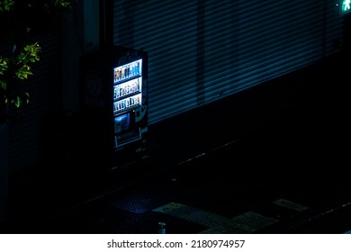 Tokyo, Japan - 06.2022: Japanese Automatic Vending Machine Of Soft Drink And Coffee On The Side Of Street And Alley At Night