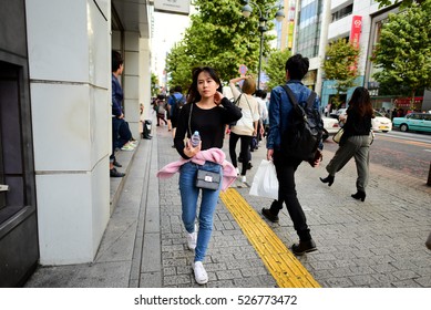 TOKYO, JAPAN - 07 OCTOBER 2016: Untitled Japanese Teenager Girl Walking On A Busy Sidewalk, In The Busy Shopping District Of Shinjuku, Tokyo.