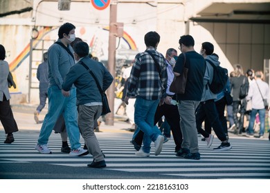 Tokyo, Japan - 10.2022: Crowd Of Pedestrian Crossing Street At Shinjuku Station During Morning Rush Hour To Commute To Work With Road Traffic Congestion