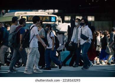 Tokyo, Japan - 10.2022: Crowd Of Pedestrian Crossing Street At Shinjuku Station During Morning Rush Hour To Commute To Work With Road Traffic Congestion