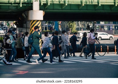 Tokyo, Japan - 10.2022: Crowd Of Pedestrian Crossing Street At Shinjuku Station During Morning Rush Hour To Commute To Work With Road Traffic Congestion