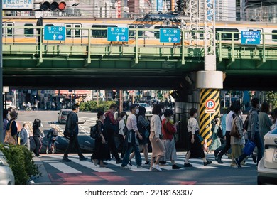 Tokyo, Japan - 10.2022: Crowd Of Pedestrian Crossing Street At Shinjuku Station During Morning Rush Hour To Commute To Work With Road Traffic Congestion