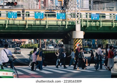 Tokyo, Japan - 10.2022: Crowd Of Pedestrian Crossing Street At Shinjuku Station During Morning Rush Hour To Commute To Work With Road Traffic Congestion