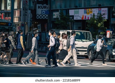 Tokyo, Japan - 10.2022: Crowd Of Pedestrian Crossing Street At Shinjuku Station During Morning Rush Hour To Commute To Work With Road Traffic Congestion