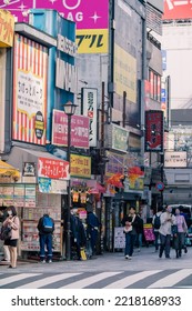 Tokyo, Japan - 10.2022: Crowd Of Pedestrian Crossing Street At Shinjuku Station During Morning Rush Hour To Commute To Work With Road Traffic Congestion