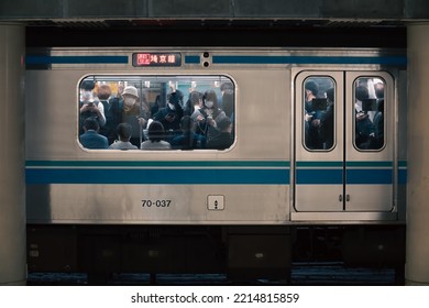 Tokyo, Japan - 10.2022: Japanese Rush Hour With Worker And Student Commuting On Express Train Crammed Into The Carriage