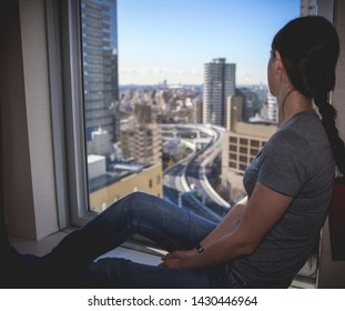 Tokyo, JAPAN - 11 January 2018 : Girl Is Watching Tokyo Aerial Highway And Skyline From Hotel Room. 