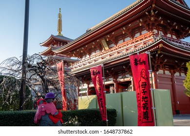 Tokyo, Japan - 18th February, 2020: Sensō-ji  temple - The Hazomon the five stories pagoda and the mother and children (or Bo-shi Jizo statue).