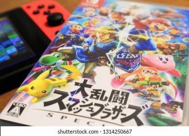 TOKYO, JAPAN. 2018 Feb 16th. Nintendo Switch And Super Smash Bros Ultimate Game On Wooden Table.