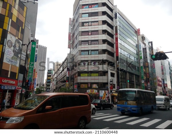 Tokyo, Japan 21 January 2022: Building with\
publicity boards and cars on the\
road