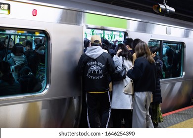 Tokyo, Japan: 25 January, 2020: Tokyo Subway Shinjuku Station At Rush Hour. People Try To Get Into Train 