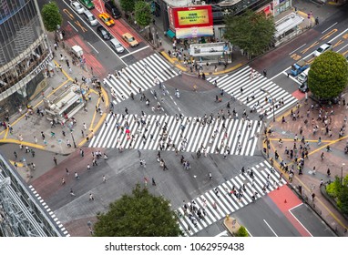 Tokyo, Japan - 26th June 2016: Ariel View Of The Busy Shibuya Crossing, Known As The Scrambles, Where Upwards Of 1000 People Cross The Street Every Time The Lights Change.