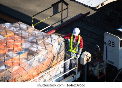 Tokyo, Japan - 8 February, 2020: Worker Is Packing Cargo To China Eastern Airplane Boeing In Haneda Airport HND (one Of Main Tokyo Airports). Air Freight To The Aircraft