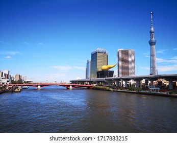 TOKYO, JAPAN - APRIL 12, 2018: View of the City of Tokyo with Tokyo Skytree which is the tallest tower in the world and the tallest structure in Japan by Sumida River 
