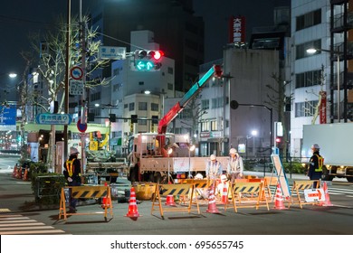 TOKYO, JAPAN - April 2014 : Construction Workers Working Maintainance The Street At Night.