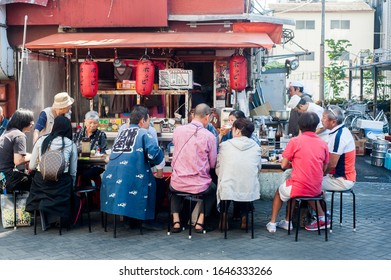 Tokyo, Japan - April 2014:
People Eating At Hawker Stand.