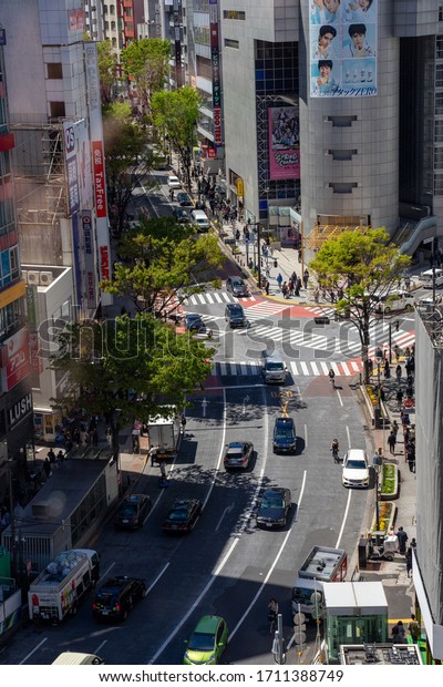 Tokyo / Japan -\
April 2019: Shibuya scramble street crossing. Thousands of people\
cross the street at the same time creating a see of people in the\
center of Tokyo in Japan.
