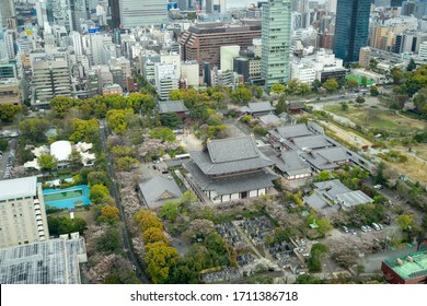 Tokyo / Japan - April 2019: Zojoji Temple during cherry blossom season in spring. Tokyo tower can be seen as well as the Tokyo skyline.
