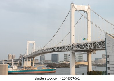 Tokyo, Japan - April, 2022: Landscape Of Rainbow Bridge, The Most Famous Bridge In Tokyo And Odaiba Area In A Cloudy Day