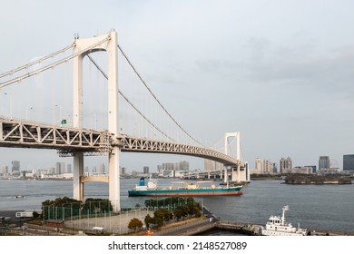 Tokyo, Japan - April, 2022: Landscape Of Rainbow Bridge, The Most Famous Bridge In Tokyo And Odaiba Area In A Cloudy Day